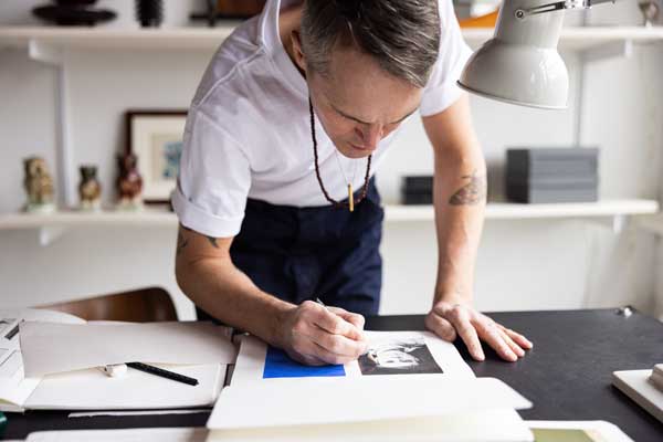 Picture of a man drawing in a book